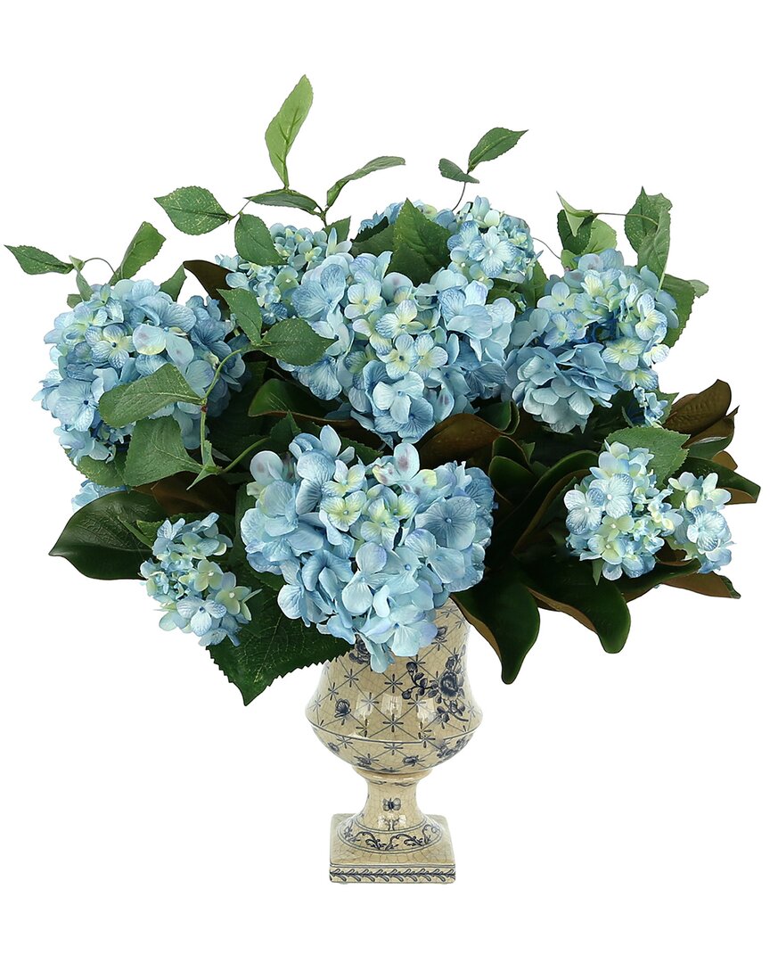 Creative Displays White Hydrangeas And Magnolia Leaves Arranged In A Decorative Ceramic Urn In Blue